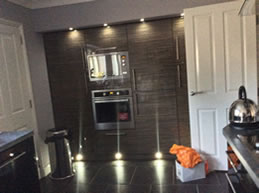 Contemporary fitted kitchen with floor to ceiling cupboards